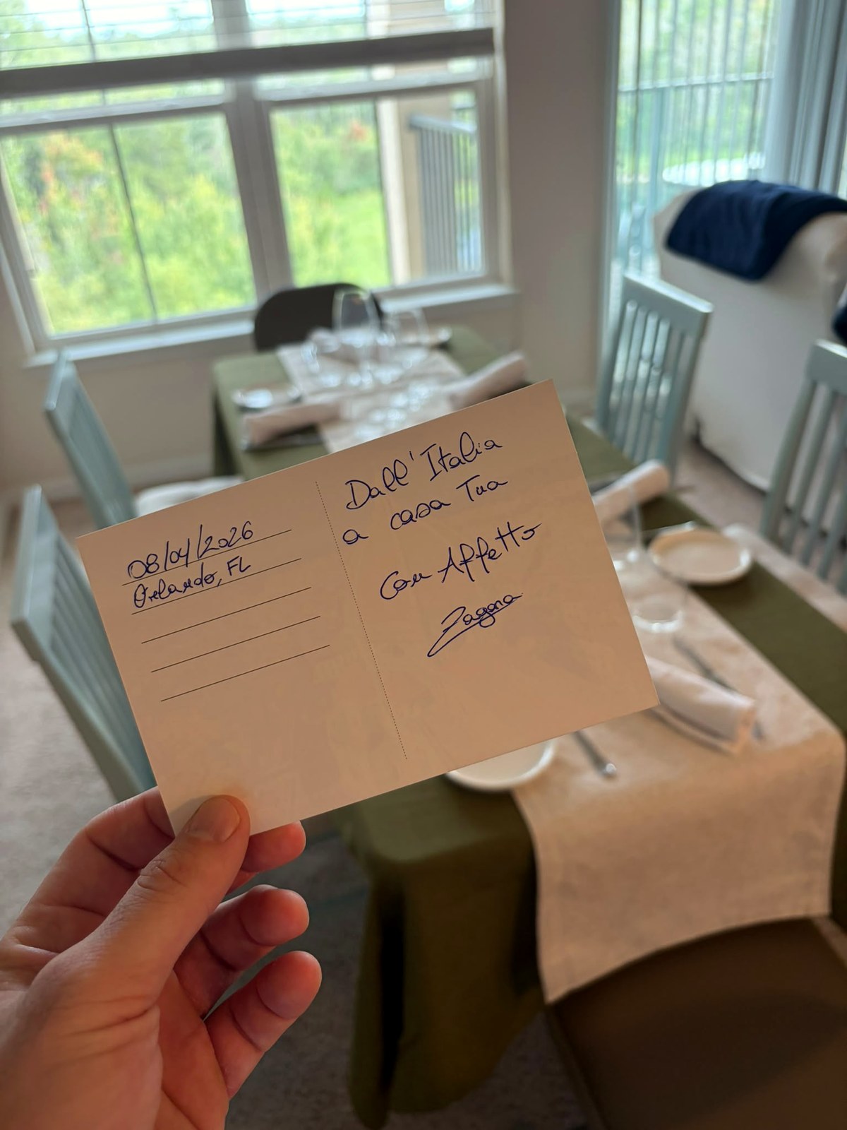 Handwritten Zagara postcard over a private dining table
